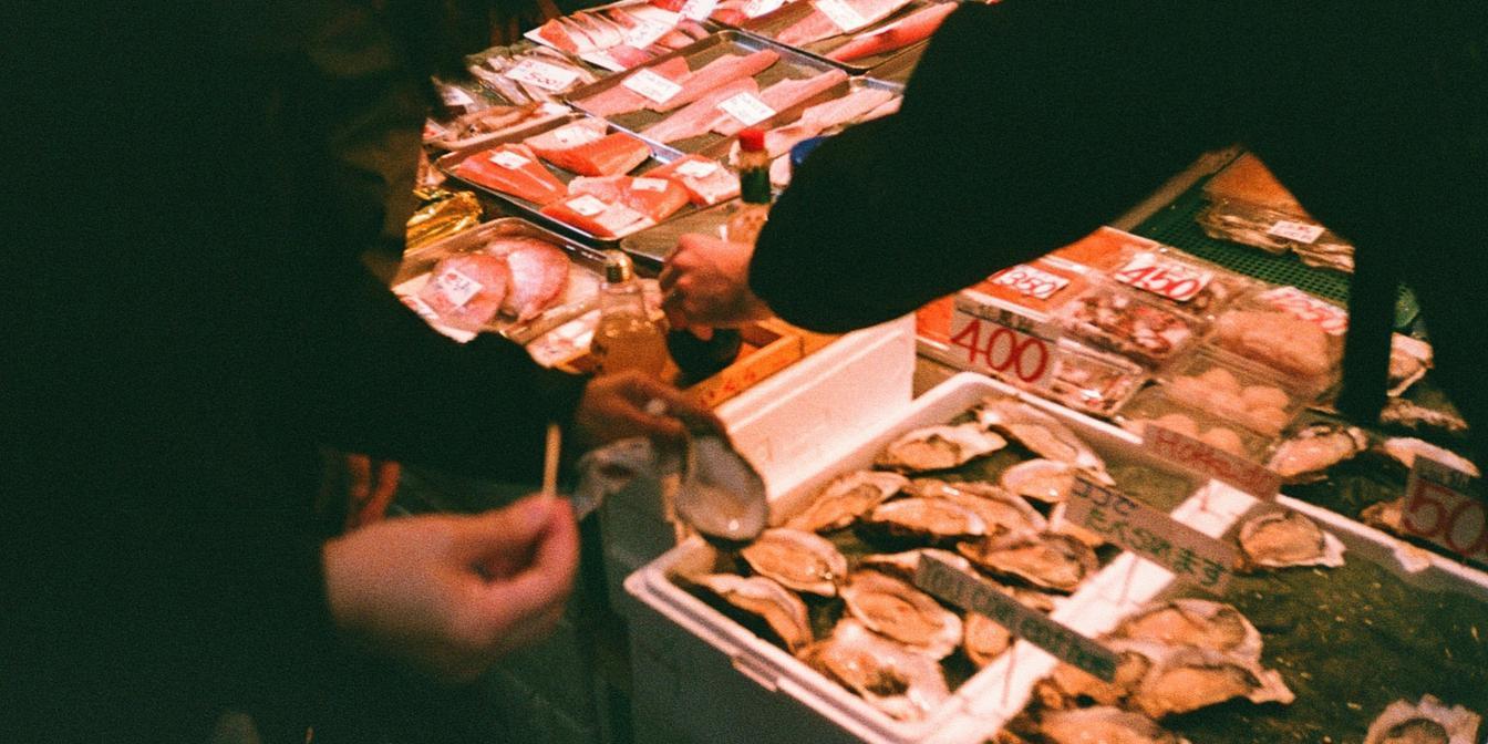 Shopper checking product labels before ordering Persian groceries