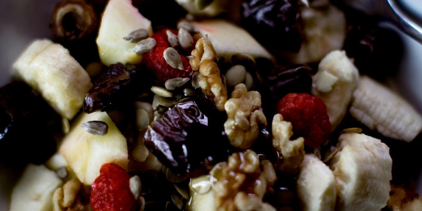 Dried fruit served in a balanced breakfast with yoghurt, oats and nuts
