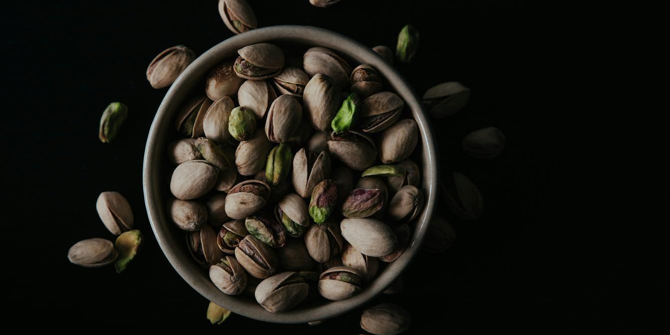 Raw unsalted and roasted salted pistachios compared side by side