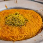 Persian saffron threads with a mortar and a dish of saffron rice