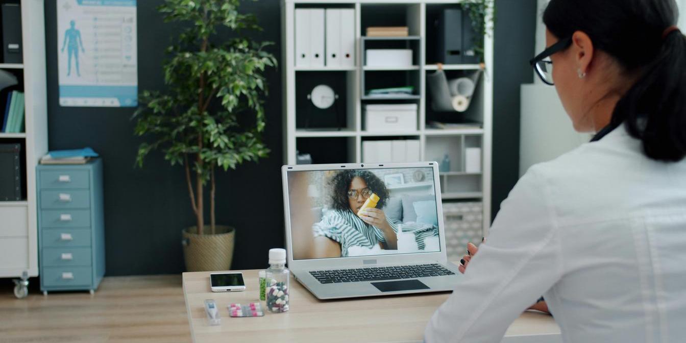 Postmenopausal woman reviewing a bone density scan with a healthcare professional
