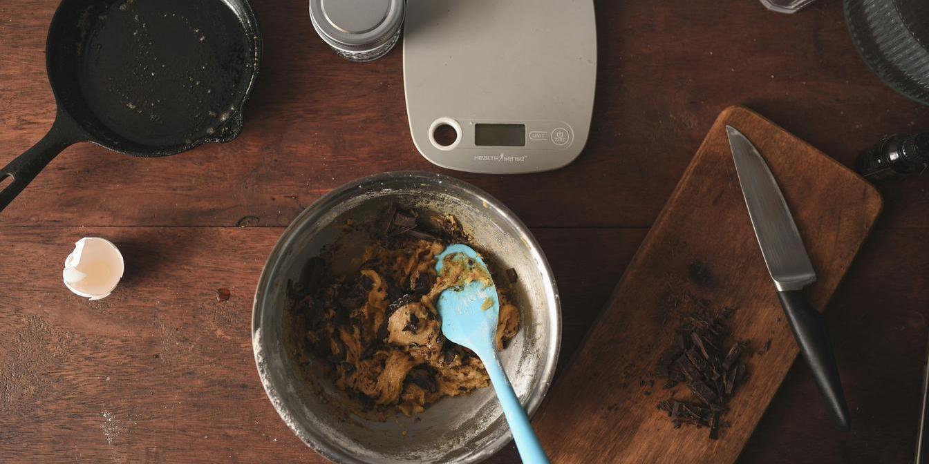 A measured portion of dried plums on a kitchen scale