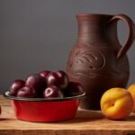 Bowl of dried plums with fresh plums, oatmeal and water as part of a fibre-rich meal