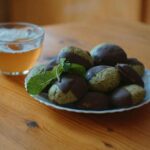 Measured serving of dried plums with a glass of water