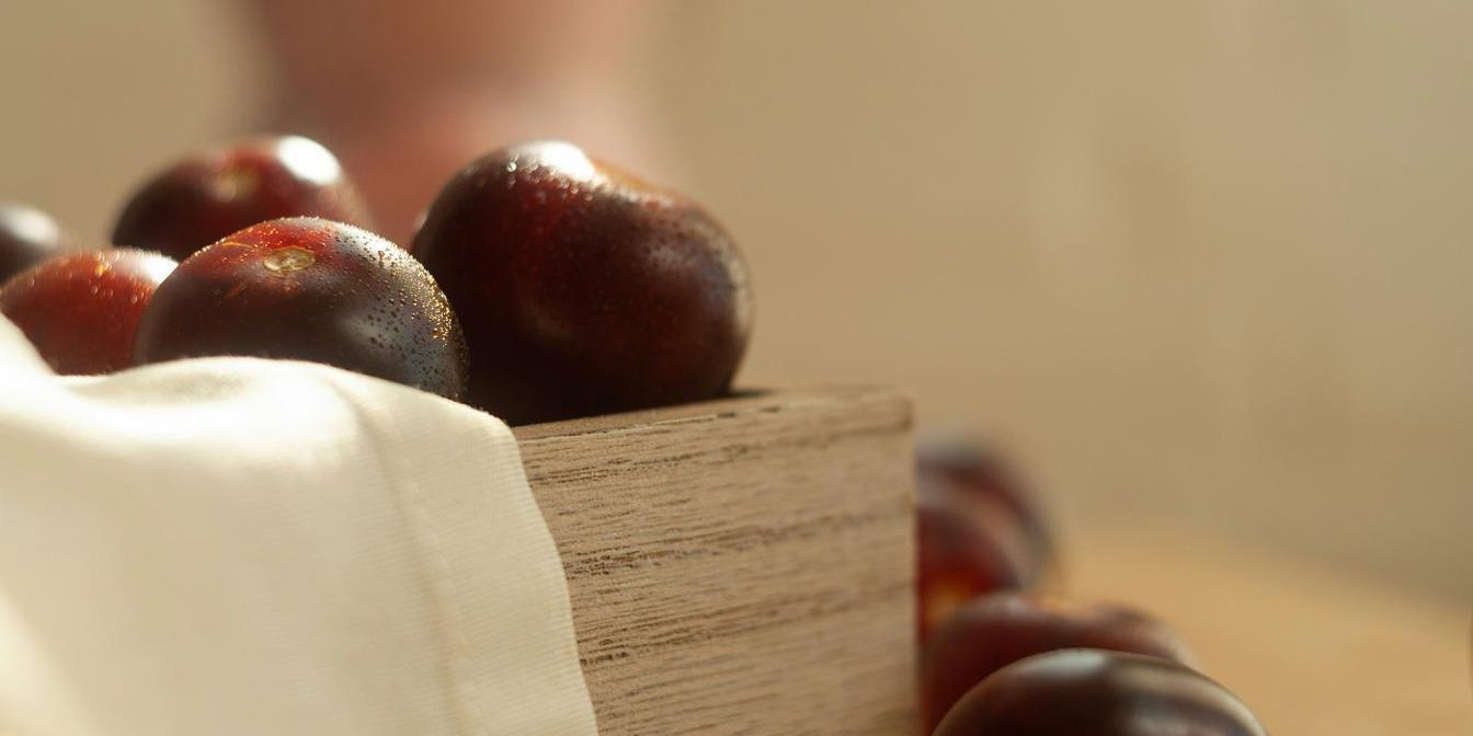 Dried plums being measured by weight on a kitchen scale