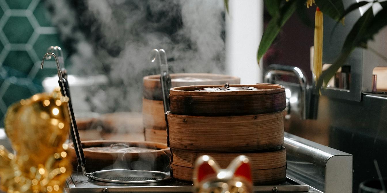 A stacked kettle and teapot setup used to keep tea concentrate warm