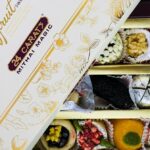 Assorted traditional Iranian sweets arranged around Persian tea