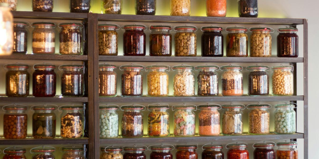 Organised cupboard containing Persian pantry staples