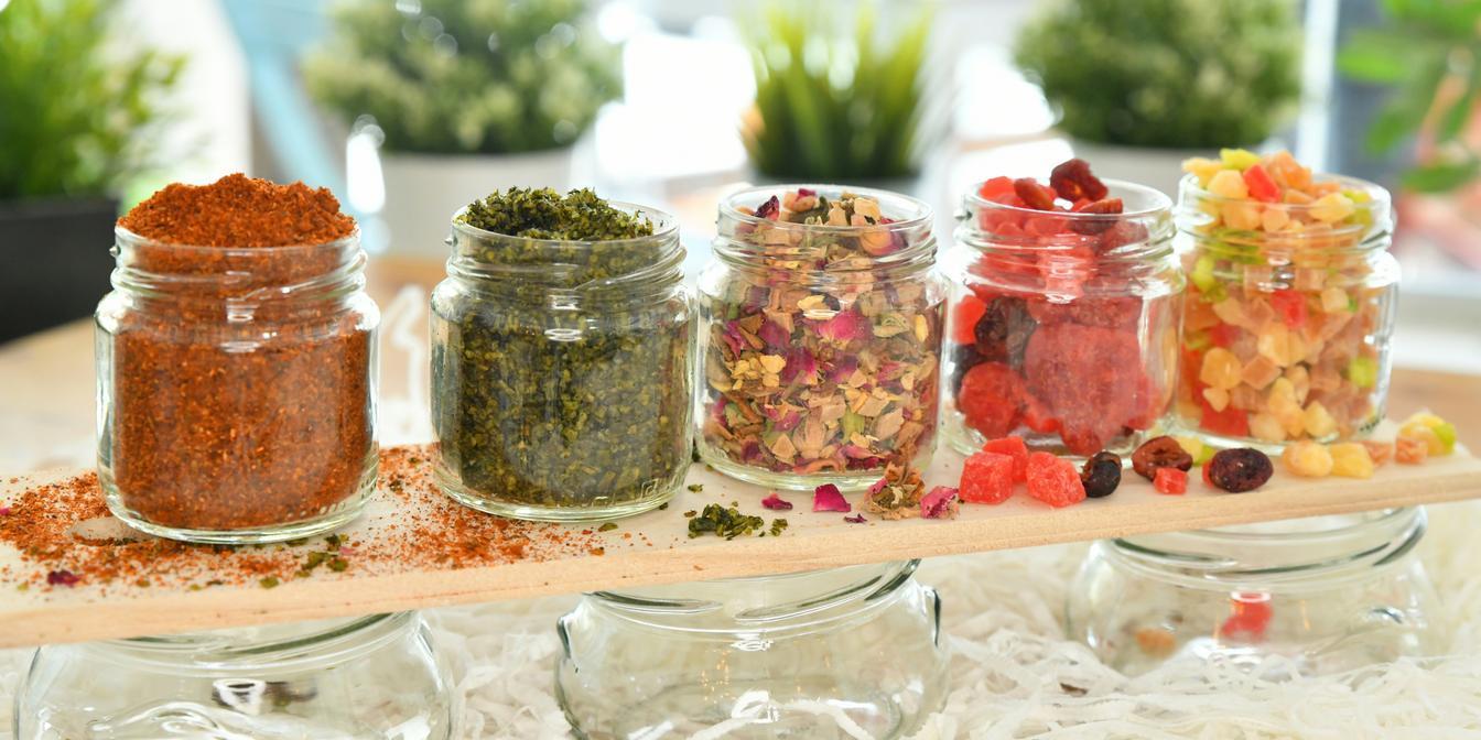 Jars of pickled vegetables served beside a rice dish