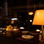 Traditional Persian tea served in clear glasses with a decorated teapot, dates and sugar